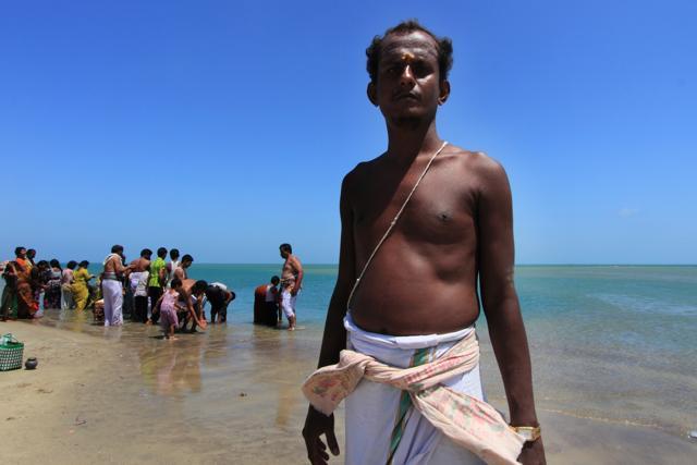 A Hindu priest performing puja at the sacred confluence in Dhanuskodi (Shutterstock) A Hindu priest performing puja at the sacred confluence in Dhanuskodi (Shutterstock)