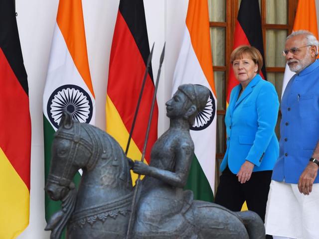 PM Narendra Modi (R) walks with German Chancellor Angela Merkel as they arrive for meetings at Hyderabad House in New Delhi on Monday. (AFP) PM Narendra Modi (R) walks with German Chancellor Angela Merkel as they arrive for meetings at Hyderabad House in New Delhi on Monday. (AFP)