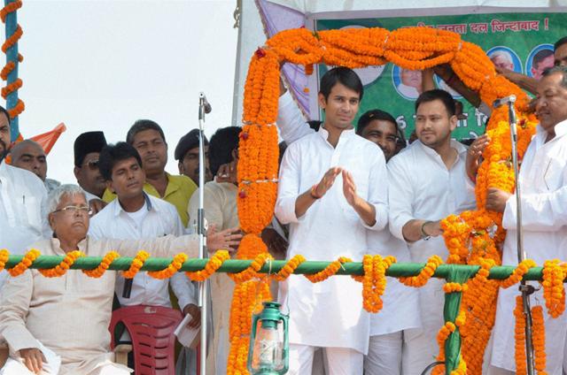 RJD chief Lalu Prasad with sons Tejaswi Yadav and Tej Pratap at a rally. An affidavit filed by Tej Pratap suggests that he is actually the younger of the pair. (PTI Photo)