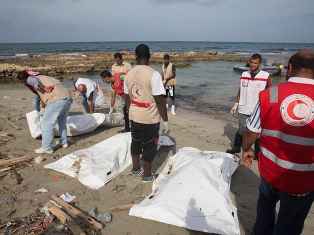 Red Crescent workers recover bodies east of Tripoli on Sunday. (AP) Red Crescent workers recover bodies east of Tripoli on Sunday. (AP)