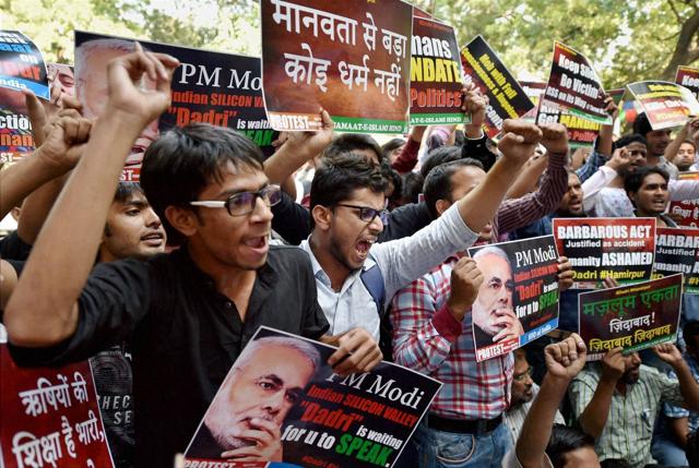 People shout slogans and carry placards during a protest at Jantar Mantar in Delhi. The protesters wanted PM Narendra Modi to speak on the murder of a Muslim man over beef in a UP village. (PTI) People shout slogans and carry placards during a protest at Jantar Mantar in Delhi. The protesters wanted PM Narendra Modi to speak on the murder of a Muslim man over beef in a UP village. (PTI)