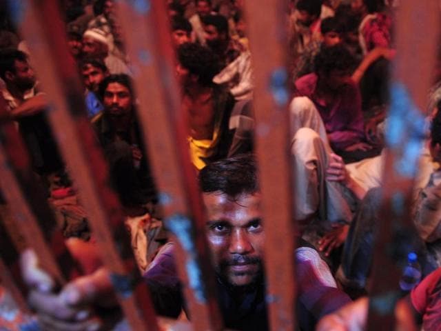 Arrested Indian fishermen gather in a police lock up in Karachi on October 4, 2015. The Pakistan maritime security agency arrested 71 Indian fishermen and seized twelve boats for illegally fishing in Pakistan's territorial waters. (AFP)
