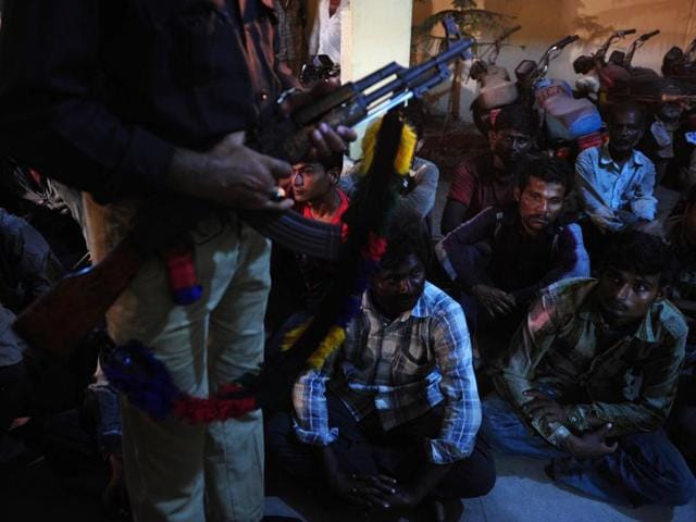 Arrested Indian fishermen sit in a police station in Karachi . (AFP)