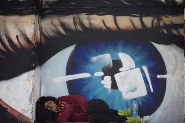 Refugees and migrants sleep in front of a graffiti covered wall depicting a human eye at the port of the city of Mytilene on the island of Lesbos, Greece, on October 6, 2015. Austrian Chancellor Werner Faymann became the first European Union leader to visit the Greek island of Lesbos to see the impact of Europe's migrant crisis on one of the refugees' preferred entry points into the EU. (Reuters Photo) Refugees and migrants sleep in front of a graffiti covered wall depicting a human eye at the port of the city of Mytilene on the island of Lesbos, Greece, on October 6, 2015. Austrian Chancellor Werner Faymann became the first European Union leader to visit the Greek island of Lesbos to see the impact of Europe's migrant crisis on one of the refugees' preferred entry points into the EU. (Reuters Photo)