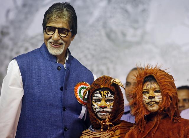 Amitabh Bachchan poses for photographs with kids dressed as tigers during the Wildlife Week celebrations in Mumbai Tuesday, Oct. 6, 2015. (AP PHOTO)