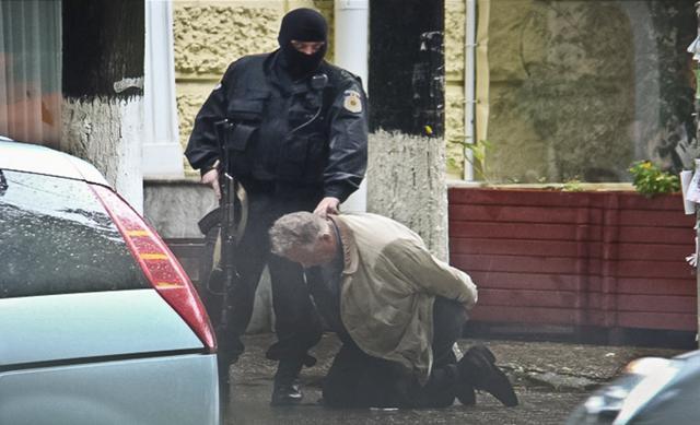 In this June 27, 2011 photo provided by the Moldova General Police Inspectorate, Teodor Chetrus is detained by a police officer in Chisinau, Moldova during a uranium-235 sting operation. (AP Photo) In this June 27, 2011 photo provided by the Moldova General Police Inspectorate, Teodor Chetrus is detained by a police officer in Chisinau, Moldova during a uranium-235 sting operation. (AP Photo)