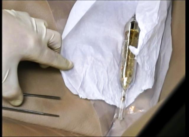 In this Feb. 19, 2015 image made from video provided by the Moldova General Police Inspectorate, an investigator looks at a vial containing cesium-135 on the driver's seat of Valentin Grossu's car following his arrest in Chisinau, Moldova. (AP Photo) In this Feb. 19, 2015 image made from video provided by the Moldova General Police Inspectorate, an investigator looks at a vial containing cesium-135 on the driver's seat of Valentin Grossu's car following his arrest in Chisinau, Moldova. (AP Photo)