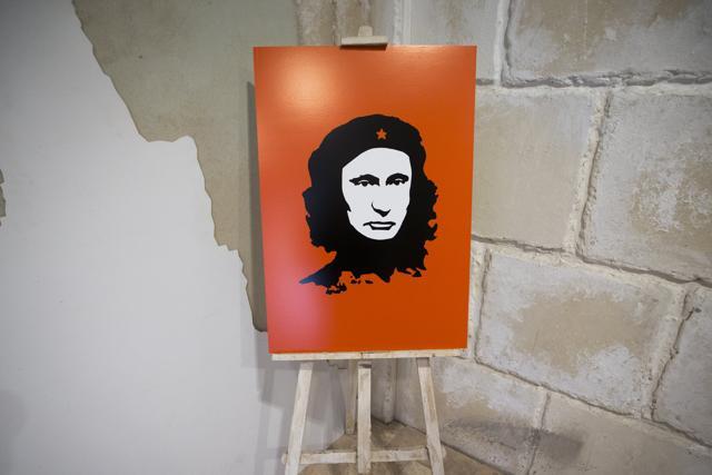 An artwork showing Russian President Vladimir Putin as Argentine revolutionary leader Ernesto Che Guevara is displayed at the "Putin Universe" exhibition. (AP Photo)