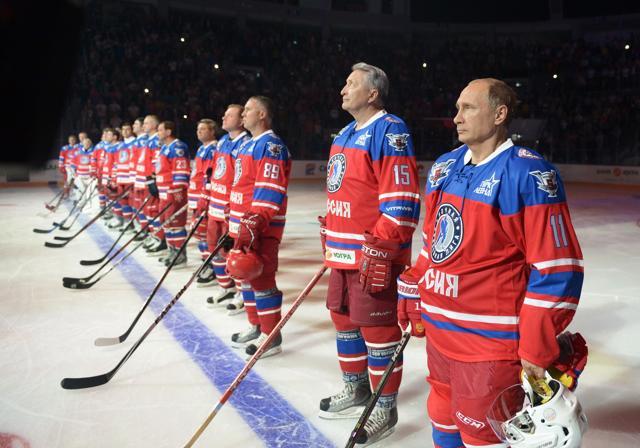 Russian President Vladimir Putin (R) takes part in a hockey match during the opening of a new season of the Night Ice Hockey League in Sochi. (AFP)