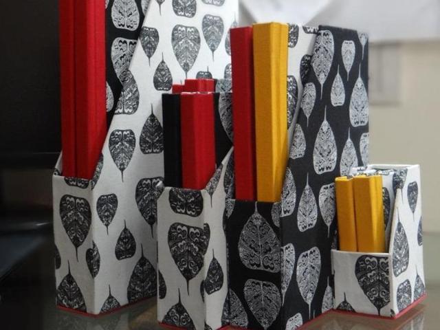 Naresh Kumar, a bookbinder and stationery maker from Delhi has bound tabletop accessories in printed cloth with motifs of Kannada letters