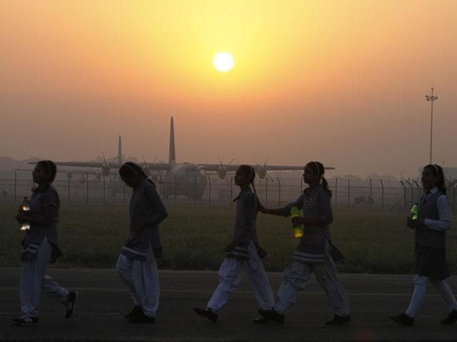 School children walk in front of Indian Air Force's transport aircraft C-17 Globemaster, ahead of the Air Force Day parade at the Hindon air force station. (Raj K Raj/ HT Photo)