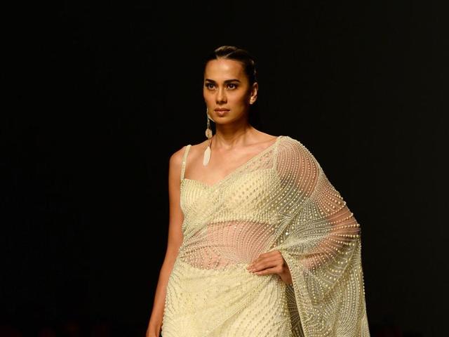 Subtle cream saree, embellished in pearl by fashion designers Rabani and Rakha. (AFP) Subtle cream saree, embellished in pearl by fashion designers Rabani and Rakha. (AFP)