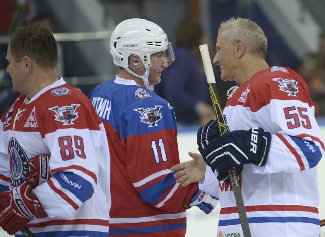 Russian President Vladimir Putin (C) in action during the game. (REUTERS)
