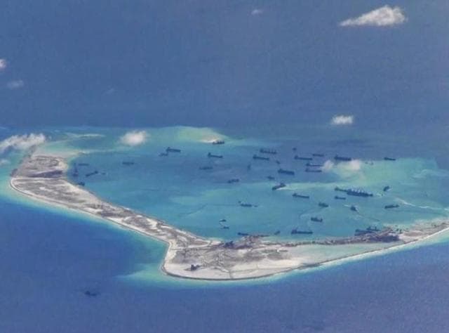 Chinese dredging vessels are purportedly seen in the waters around Mischief Reef in the disputed Spratly Islands in the South China Sea in this still image from video taken by a P-8A Poseidon surveillance aircraft provided by the United States Navy. (Reuters File)