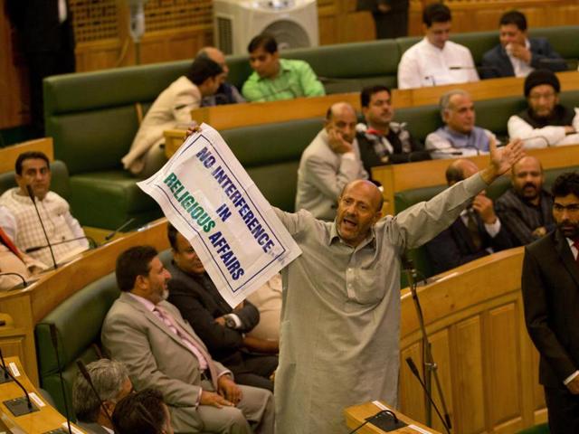 Engineer Rashid, an independent legislator, holds a banner as he disrupts the first day of Jammu and Kashmir state assembly session in Srinagar. (AP) Engineer Rashid, an independent legislator, holds a banner as he disrupts the first day of Jammu and Kashmir state assembly session in Srinagar. (AP)