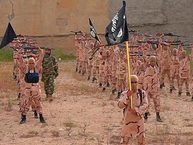 In this photo released on April 25, 2015, by a militant website, young boys hold rifles and Islamic State group flags as they exercise at a training camp in Tal Afar, near Mosul, northern Iraq. (Militant website via AP) In this photo released on April 25, 2015, by a militant website, young boys hold rifles and Islamic State group flags as they exercise at a training camp in Tal Afar, near Mosul, northern Iraq. (Militant website via AP)