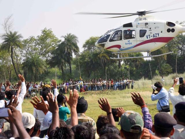 Supporters wave at the helicopter of Bihar chief minister Nitish Kumar as he leaves after an election rally in Imamganj area in Gaya. (PTI)