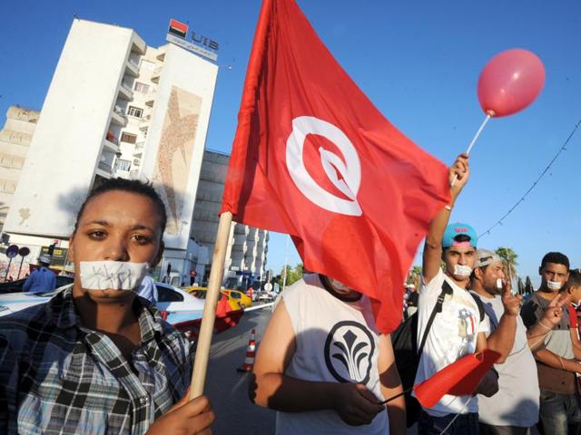 A photo taken on August 11, 2013 shows a Tunisian demonstrator waving with her national flag during a protest against their Islamist government in Tunis. Tunisian mediators of the socalled National Dialogue Quartet won the 2015 Nobel Peace Prize. (AFP) A photo taken on August 11, 2013 shows a Tunisian demonstrator waving with her national flag during a protest against their Islamist government in Tunis. Tunisian mediators of the socalled National Dialogue Quartet won the 2015 Nobel Peace Prize. (AFP)
