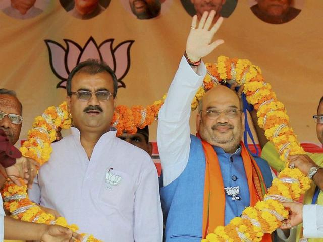 BJP National president Amit Shah being garlanded during a public rally at Rajendra Stadium in Katihar, Bihar on Sunday. (PTI)