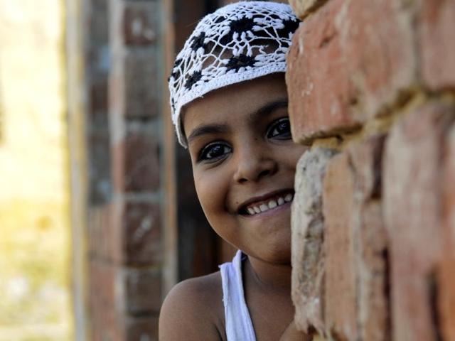 A child peeps through the door of a mosque in Dadri’s Bisada village, which is slowly limping back to normalcy after days of tension following the lynching of a man over rumours that he ate beef. (Sunil Ghosh / HT Photo)
