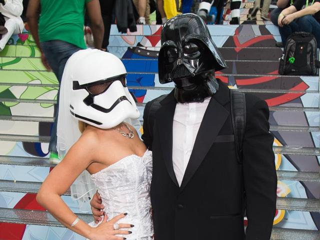 Bride and groom? Stormtrooper and Darth Vader walk the floor of New York Comic Con at the Javits Center. (AP)