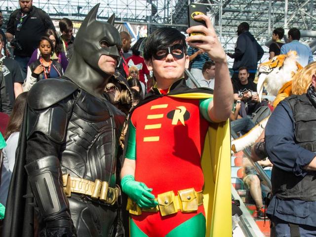 Attendees dressed as Batman and Robin take a selfie during New York Comic Con at the Javits Center. (AP)