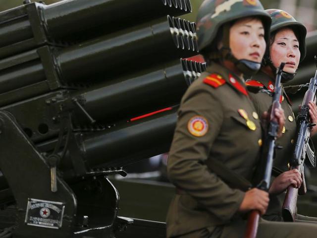 A soldier (R) cries as her vehicle with rocket launchers drives past a stand with North Korean leader Kim Jong Un during a parade celebrating the 70th anniversary of the founding of the ruling Workers' Party of Korea, in Pyongyang. (REUTERS)