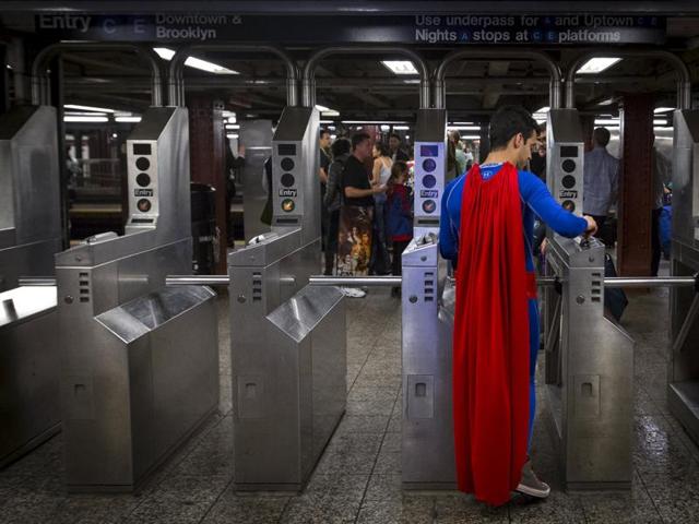 A man in a Superman costume enters the subway at the conclusion of day two of New York Comic Con in Manhattan. (REUTERS)