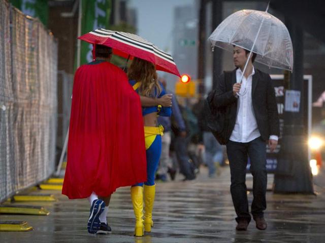 New York Comic Con attendees walk through the rain. (REUTERS)