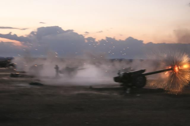Syrian army howitzers fire near the village of Morek in Syria. The Syrian army has launched an offensive this week in central and northwestern Syria aided by Russian airstrikes. (AP Photo)