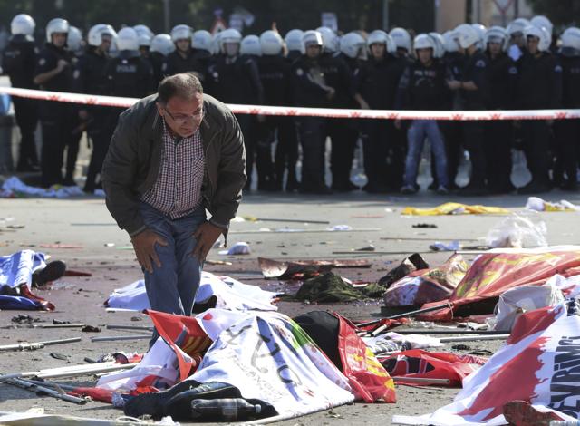 A man stands over the body of a victim at the scene of an explosion in Ankara. (AP) A man stands over the body of a victim at the scene of an explosion in Ankara. (AP)
