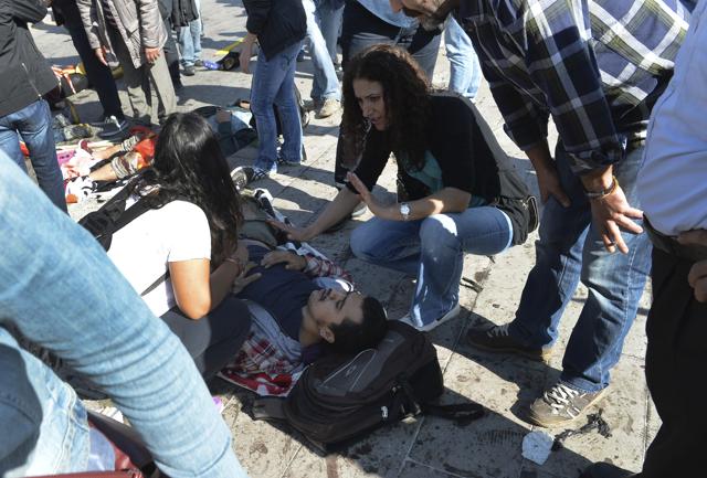 People tend to a victim at the site of an explosion in Ankara. (AP) People tend to a victim at the site of an explosion in Ankara. (AP)