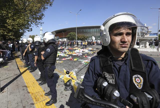 Turkish police officers secure the area at the site of an explosion, where the bodies of victims were covered with flags and banners, in Ankara, Turkey, Saturday, Oct. 10, 2015. (AP Photo) Turkish police officers secure the area at the site of an explosion, where the bodies of victims were covered with flags and banners, in Ankara, Turkey, Saturday, Oct. 10, 2015. (AP Photo)