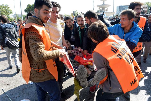 An injured person is carried away following a blast at a peace rally in Ankara . The rally was organised by leftist and pro-Kurdish groups. (AFP Photo)