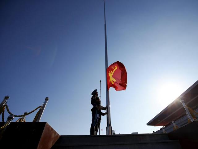 A North Korean soldier lifts a flag of the Workers' Party of Korea at the start of the parade celebrating the 70th anniversary of its founding in Pyongyang. (REUTERS)