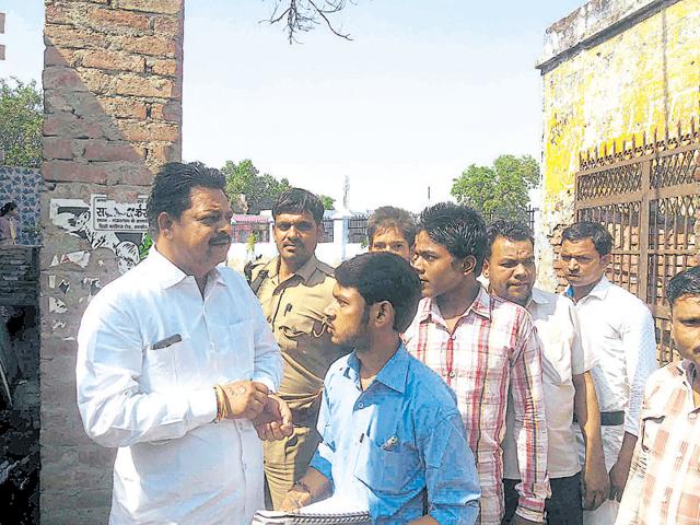 Members of the UP state SC/ST commission meet the aggrieved family before announcing the report’s findings.(HT Photo)