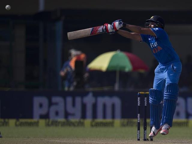 Rohit Sharma plays a shot during India’s chase. (AP Photo)
