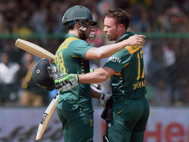 AB De Villiers, right, hugs Farhaan Behardien after completing his century. (PTI Photo)