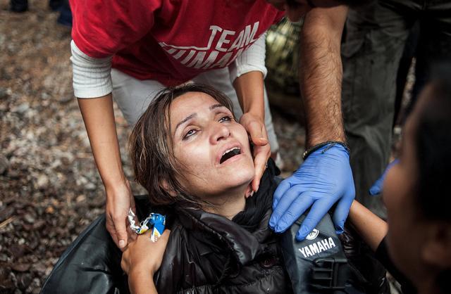A migrant woman is helped by volunteers after arriving by an overcrowded dinghy on the Greek island of Lesbos. (REUTERS) A migrant woman is helped by volunteers after arriving by an overcrowded dinghy on the Greek island of Lesbos. (REUTERS)