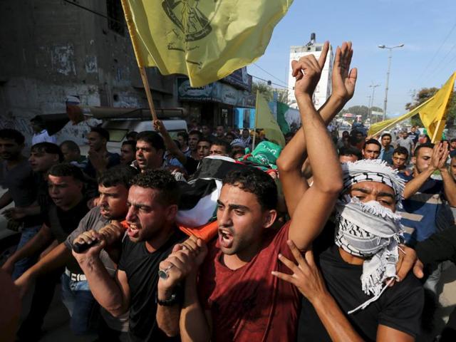 Mourners carry the body of Palestinian boy Marwan Barbakh, 12, who was shot dead by Israeli forces on Saturday.(REUTERS)