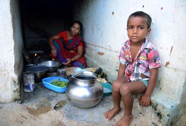 Lambadi tribal child K Jagan (R), who lost his father in a road accident, sits with his mother K Mangi at their home in the village of Peddakunta. (AFP) Lambadi tribal child K Jagan (R), who lost his father in a road accident, sits with his mother K Mangi at their home in the village of Peddakunta. (AFP)