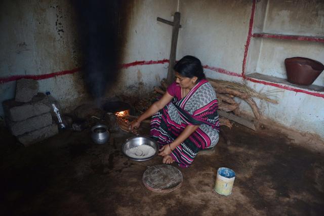 Lambadi tribal widow K Vijaya, who lost her husband in a road accident, prepares food at her home. (AFP) Lambadi tribal widow K Vijaya, who lost her husband in a road accident, prepares food at her home. (AFP)