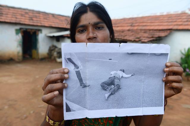 Tribal widow K Panna shows a picture of her husband after his death in a road accident. (AFP) Tribal widow K Panna shows a picture of her husband after his death in a road accident. (AFP)