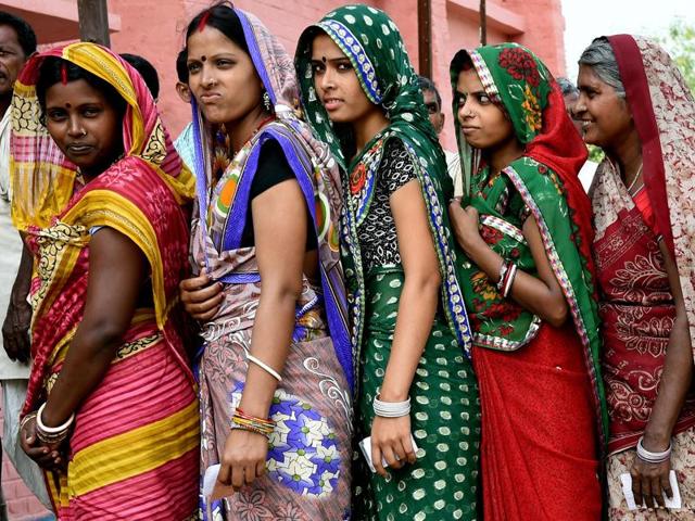 Voters queue to cast their ballots at a voting centre in the village of Banbira in Samastipur district. (AFP)