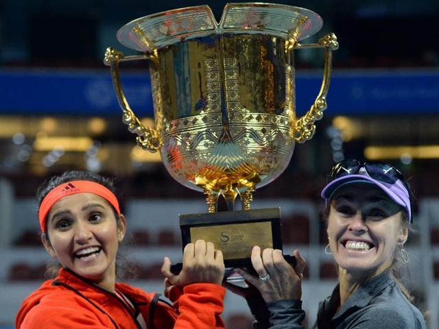Martina Hingis, right, and Sania Mirza celebrate with the trophy after winning the final of the China Open against Taiwan’s Yung-Jan Chan and partner Hao-Ching Chan in Beijing, on October 10, 2015. (AFP Photo) Martina Hingis, right, and Sania Mirza celebrate with the trophy after winning the final of the China Open against Taiwan’s Yung-Jan Chan and partner Hao-Ching Chan in Beijing, on October 10, 2015. (AFP Photo)