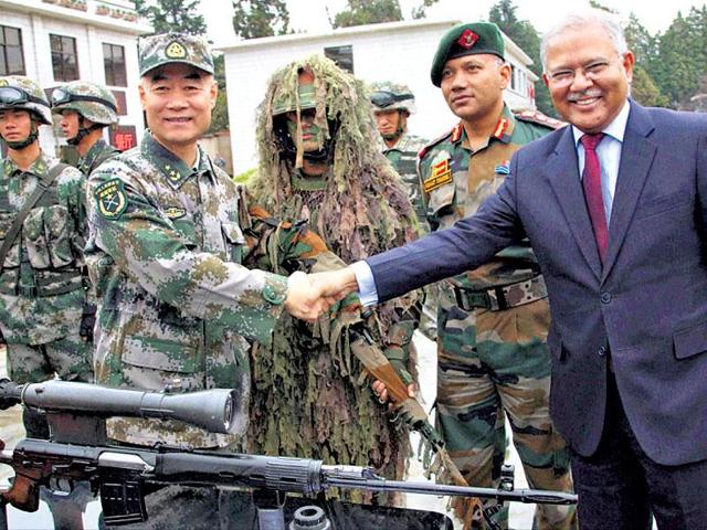 Lt Gen Zhou Xiaozhou shakes hands with Indian Ambassador Ashok K Kantha at Kunming Military Academy in Yunnan on Monday. (PTI Photo) Lt Gen Zhou Xiaozhou shakes hands with Indian Ambassador Ashok K Kantha at Kunming Military Academy in Yunnan on Monday. (PTI Photo)