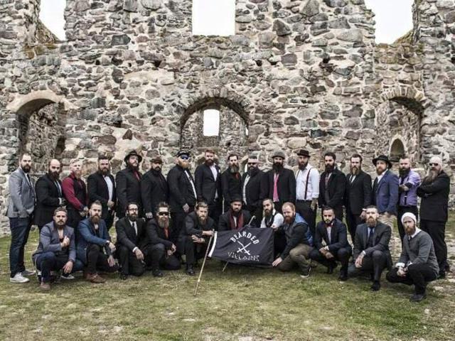 A club of bearded men posing for a photograph in the Swedish countryside with their black flag was mistaken for IS militants (Photo courtesy: Bearded Villains Facebook page) A club of bearded men posing for a photograph in the Swedish countryside with their black flag was mistaken for IS militants (Photo courtesy: Bearded Villains Facebook page)