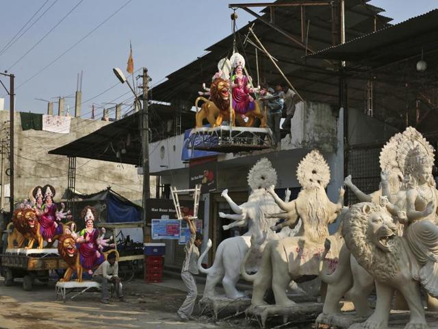 Workers bring an idol of Durga for Navratri celebrations in Hyderabad. (AP)