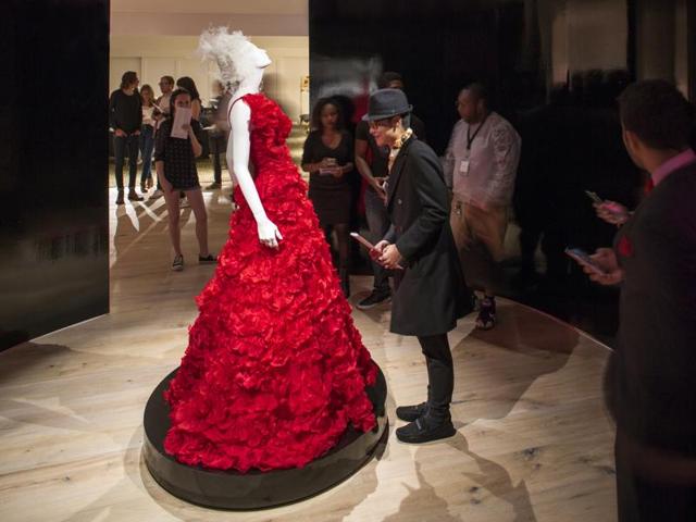 This October 2015 photo provided by the SCAD FASH museum shows a red gown designed by Oscar de la Renta forBeyonce, on display at the museum on the Atlanta campus of the Savannah College of Art and Design. (AP)