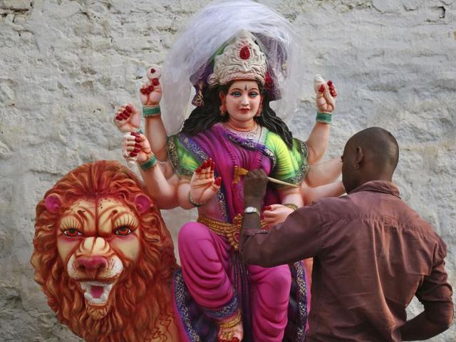 An Indian artist gives finishing touches to an idol of Hindu Goddess Durga for Navratri celebrations in Hyderabad. (AP)
